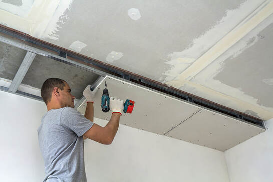 worker using a driller for mold removal, Mississuaga